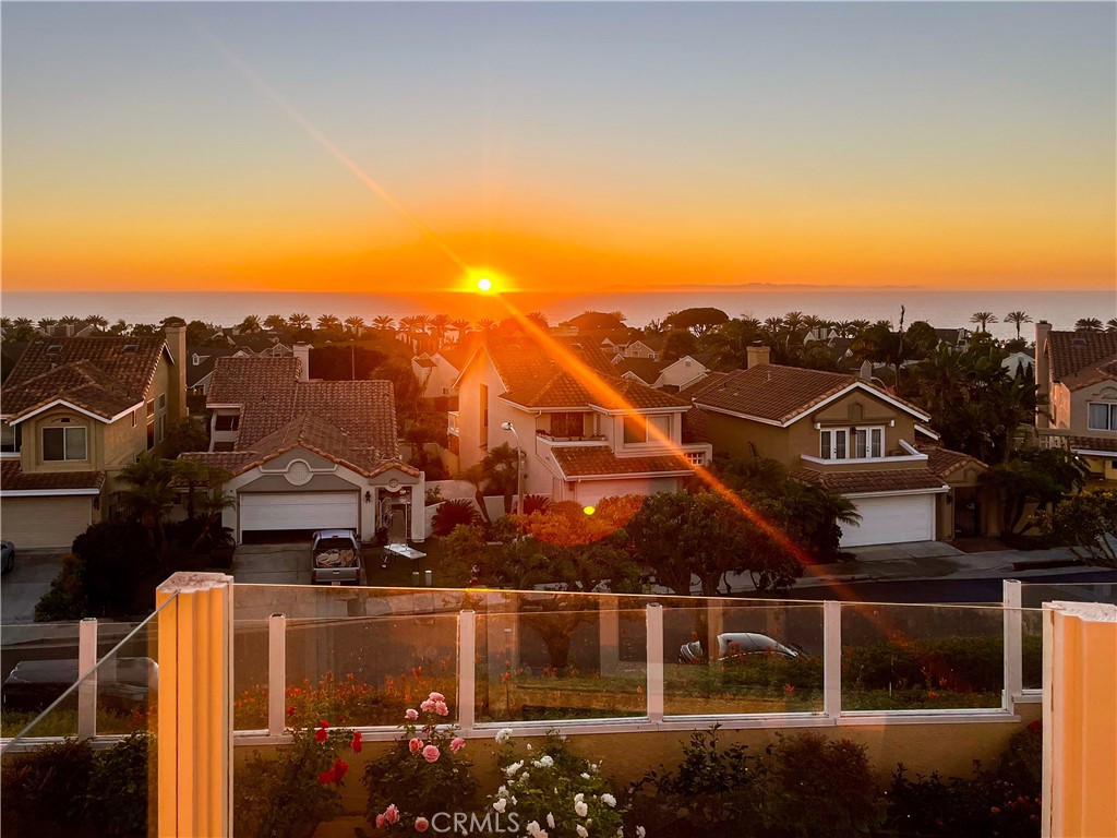 Discover the essence of coastal living in this remarkable home, offering expansive breathtaking ocean views just a few blocks from the beach. You can easily stroll to downtown shops, pubs, and restaurants, as well as Dana Point Harbor, Strands and Salt Creek Beaches. This home is more than just a residence; it's a gateway to a vibrant coastal lifestyle! As you enter this beautiful home, you'll be greeted by an open floor plan, high ceilings, and stunning ocean vistas from almost every room. Upgrades include a custom floor plan with an expanded great room, a remodeled and enlarged kitchen, new gorgeous white oak hardwood floors throughout, and a newly renovated primary bathroom. The updated double-paned windows, sliding doors, and French doors ensure a bright and inviting atmosphere. The charming courtyard entrance opens to a spacious wrap-around yard, perfect for relaxation, entertaining, or simply enjoying the ocean views. Located in the exclusive gated community of Regatta, this coastal neighborhood features just over a hundred homes, offering a perfect blend of privacy and community, perfect for a full time home or second home. With a low tax rate, new AC, fabulous location, incredible ocean views, 2200 square feet of interior living space and access to the Regatta community pool and spa, this home is ideal for those seeking the ultimate coastal lifestyle. Don't miss the chance to make this beach-close haven your own and experience all that Dana Point and South County living has to offer. Schedule a viewing today to explore the endless possibilities!