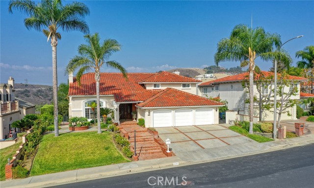 Alluring custom-built dream estate nestled in the highly coveted and guard-gated community, "Friendly Hills Estates". Enter through grand double doors and step into a gorgeous foyer w/a stunning spiral staircase, adjacent to a grand formal living rm complete with a floor-to-ceiling fireplace & formal dining rm, ALL perfect for entertaining! This 5-bed,4.5 bath estate offers so much! Embrace a lush and inviting master bedroom suite upstairs complete with updated flooring, jacuzzi jetted spa tub, oversized walk-in closet, & personal oak-paneled library/retreat sitting area! The master bath includes updated flooring, newly built designer cabinetry w/stunning marbled slab countertops. Enjoy the breeze on the outdoor viewing deck overlooking panoramic city lights & mountain views. Upstairs also features 3 other spacious JR suites with big closets, new wood-tiled flooring, & views, as well! Moreover, the main levels feature 1 bedroom w/a fully upgraded bathroom and 2 spacious closets (1 walk-in), there's also a guest powder bathroom for guests, a stunning chef's dream kitchen complete w/farm-style utility sink, beautiful granite countertops, intricate beautifully constructed wooden cabinetry, a large walk-in pantry, recessed lights, & high-end designer built-in stainless steel appliances including a new overhead exhaust fan. Take a step further into the connected family rm complete w/a custom, trendy wet bar perfect for hosting and for admiring the beautiful outdoor views from the large viewing deck. Both the kitchen & family rm are inlaid w/ high-quality walnut-colored engineered hardwood. The backyard oasis features a segregated outdoor space built out below the expansive viewing deck w/easy access and available electrical utility connection present. This usable space can be converted to another room or further built out for other creative/practical uses. Easily convertible and is currently used as storage space. Surrounding, admire the beautifully manicured lawns and landscaping w/efficient & updated irrigation drip systems in place, built-in brick BBQ w/'Viking' high-end appliances, and enjoy the tiered levels outlining the backyard boasting rows of mature fruit trees (apple, passion fruit, guava, 2 tangerine trees, pomegranate, grapefruit, peach wild figs, lemon), homegrown sweet potato leaf, fragrant osmanthus, a variety of other plant species, florals, & exotic trees. Come see to appreciate & make this incredible home yours!