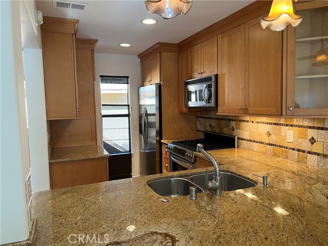 remodeled kitchen with granite counters and stainless steel appliances