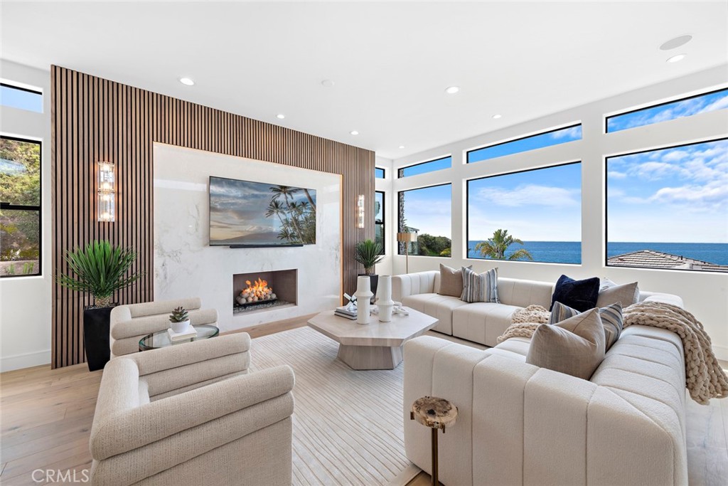 Located on Laguna’s famed Skyline Drive, enjoy nightly Catalina Island sunsets and breathtaking views of Laguna’s northern coastline from this fully renovated contemporary stunner. Every inch of this incredible property boasts impeccable style, expertly crafted by a team of the finest designers, with sun-drenched interiors spanning 2,780 s.f. +/-, and offering 4 bedrooms and 4 bathrooms. Luxe finishes are found throughout, including Onyx Glass windows, custom paint, Sonos audio, and Provenza Old World hardwood floors. The living room is a dramatic perch where expanses of glass offer mesmerizing ocean views, and an exquisite fireplace with concrete spheres is set in a lavish wall of marble and wood. In the dining room, glass orbs casts glowing light on an upscale bar that offers a marble waterfall counter, and a beverage cooler that chills 18 bottles or 57 cans. Rare upgrades include a built-in wood bench, and a spacious balcony that embodies the essence of coastal living with sweeping ocean and canyon views. Effortlessly sleek, the kitchen is a masterpiece of modern design, featuring imported Bardiglio Versilis marble counters, stained rift oak cabinets, a farmhouse sink, and a backsplash of Sessemo Raku tiles. Whether hosting a casual gathering or elaborate full-course meal, topline appliances create culinary magic, with a SubZero refrigerator, 24” Thermador gas range with double convection ovens, Thermador dishwasher, and a Sharp microwave drawer. The main floor is completed by a powder room, and master bedroom suite where a balcony opens to salt air breezes, and upgrades include two walk-in closets, and a stunning ensuite that offers a soaking tub and a shower clad in Terrazo tile with dual, multi-function shower heads. Three downstairs bedrooms are infused with natural light and upscale details. A junior suite offers a sitting area, a frameless glass window, ocean-view balcony, and a bathroom with floor-to-ceiling tile and a floating vanity. Two additional bedrooms include a guest room with ensuite bath. Set on a hillside property with 12,760 s.f. +/-, this home is engineered with advanced technology that reinforces foundations deep into bedrock with steel concrete columns, creating an earthquake resistant structure of lasting quality. Experience the enviable Laguna Beach lifestyle, with a location that’s minutes from the beach and village with exquisite dining, eclectic boutiques & art galleries, renowned cultural events, biking, swimming & surfing. Located on Laguna’s famed Skyline Drive, enjoy nightly Catalina Island sunsets and breathtaking views of Laguna’s northern coastline from this fully renovated contemporary stunner. Every inch of this incredible property boasts impeccable style, expertly crafted by a team of the finest designers, with sun-drenched interiors spanning 2,780 s.f. +/-, and offering 4 bedrooms and 4 bathrooms. Luxe finishes are found throughout, including Onyx Glass windows, custom paint, Sonos audio, and Provenza Old World hardwood floors. The living room is a dramatic perch where expanses of glass offer mesmerizing ocean views, and an exquisite fireplace with concrete spheres is set in a lavish wall of marble and wood. In the dining room, glass orbs casts glowing light on an upscale bar that offers a marble waterfall counter, and a beverage cooler that chills 18 bottles or 57 cans. Rare upgrades include a built-in wood bench, and a spacious balcony that embodies the essence of coastal living with sweeping ocean and canyon views. Effortlessly sleek, the kitchen is a masterpiece of modern design, featuring imported Bardiglio Versilis marble counters, stained rift oak cabinets, a farmhouse sink, and a backsplash of Sessemo Raku tiles. Whether hosting a casual gathering or elaborate full-course meal, topline appliances create culinary magic, with a SubZero refrigerator, 24” Thermador gas range with double convection ovens, Thermador dishwasher, and a Sharp microwave drawer. The main floor is completed by a powder room, and master bedroom suite where a balcony opens to salt air breezes, and upgrades include two walk-in closets, and a stunning ensuite that offers a soaking tub and a shower clad in Terrazo tile with dual, multi-function shower heads. Three downstairs bedrooms are infused with natural light and upscale details. A junior suite offers a sitting area, a frameless glass window, ocean-view balcony, and a bathroom with floor-to-ceiling tile and a floating vanity. Two additional bedrooms include a guest room with ensuite bath. Set on a hillside property with 12,760 s.f. +/-, this home is engineered with advanced technology that reinforces foundations deep into bedrock with steel concrete columns, creating an earthquake resistant structure of lasting quality. Experience the enviable Laguna Beach lifestyle, with a location that’s minutes from the beach and village with exquisite dining, eclectic boutiques & art galleries, renowned cultural events, biking, swimming & surfing.