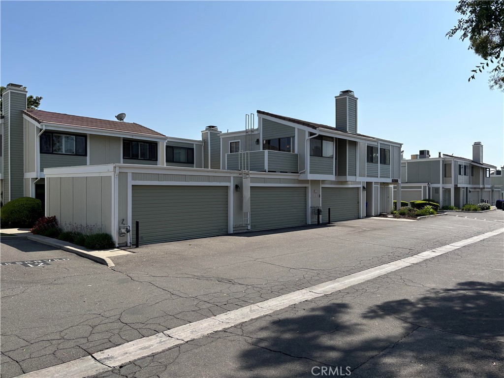 Great Penthouse Unit.  Wonderful Open Floor Plan. Great Room has lots of natural light, cozy fireplace and access to Balcony with nice view of the grounds and surrounding foothills. Carpet installed in June 2025. Dining Area has ceiling fan.   Kitchen has newer refrigerator, stove and microwave (all included). Primary Bedroom is roomy with long mirrored wardrobe closet. Full Bathroom attached to Primary Bedroom. Secondary Bedroom could be used as an office. Additional Powder Room.  Indoor Laundry Closet with Washer & Dryer (included). Detached Two Car Garage with some storage shelving. HOA has pool, spa and tennis courts.