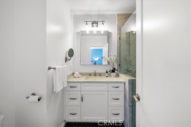 Primary bathroom with walk-in shower and seat