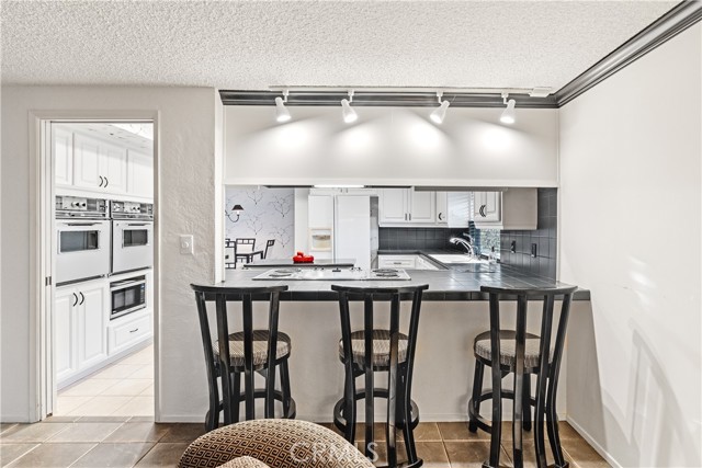 The breakfast bar at the family room is a wonderful feature bring the family room and kitchen together as a great room.