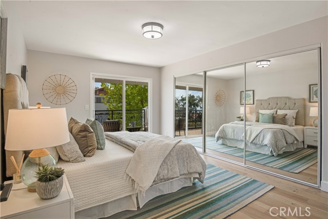 Three mirrored closet doors, this bedroom also has direct access to the balcony.