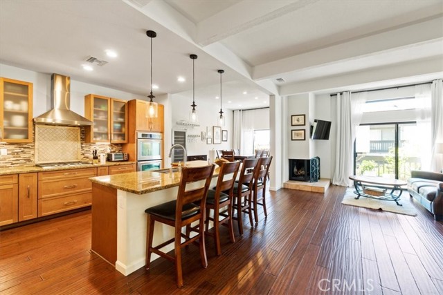 1544 Michael Lane Pacific Palisades, California This bright, open, and contemporary floor plan welcomes you with gorgeous mountain views of the Palisades Highlands. Each of the 3 levels of this nearly 2,500 square foot town home connects you outside. Find your bliss in this turn-key, move-in ready home. All 3 bedrooms on the top floor have blackout shades. The large primary suite boasts a 15-foot vaulted ceiling, gas fireplace, private balcony with mountain views, and a renovated en suite bathroom with two sinks, double soaking tub and walk-in shower. The walk-in closet is fully designed with attic access. The 2 additional large bedrooms, each with 15-foot vaulted ceilings, are situated across from a shared bathroom. A large skylight bathes the home with diffused natural light down the open stairwell. The middle level is perfect for entertaining with a Tuscan-style, open kitchen overlooking the dining and living rooms. Beside the wood-burning fireplace in the living room, enjoy the mountain breezes and views on the large balcony. The powder room includes a new vanity, sink, mirror, and lighting fixture. The updated kitchen has a large central island with stainless steel sinks, a new dishwasher, and conveniently located electric double ovens adjacent to a large counter with central cook-top. Over 140 cubic feet of cabinet space fulfills all your kitchen storage needs. Unload the groceries directly from car-to-kitchen from the 2-car garage. In the garage, brand new doors tastefully cover the washer/dryer, water heater, H VAC unit, and storage space. Floating floor tiles clean to a shine. The lower level is a versatile entertainment room with new Italian floor tiles and built-in entertainment center. Close the French doors, lower the custom-made, solid-wood Murphy bed, and create a guest bedroom suite with renovated bathroom. The lower level opens to a private patio with natural gas connection. This home includes energy-efficient double paned windows/sliding doors, new door handles, and updated light fixtures. Steps away from the garage is the renovated gym and steam room by the outdoor heated pool and spa. Location is 4 min. from the beach, 2 min. to hiking trails, and 7 min. from Palisades Village shops/restaurants. HOA member of the Palisades Drive Recreation private playground/park/dog park.