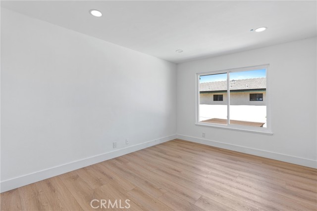 Second Bedroom with Recessed lights, new flooring, and dual pane windows.