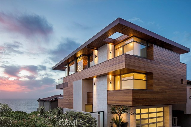 2615 Crest Drive Manhattan Beach, California CLOUD 9....This residence is the star property on the biggest ocean view street in Manhattan Beach. Thrilling whitewater ocean views are of a soulful operatic experience, and its surreal sunsets are flawless. Even the marine layer sounds and feels like Amazing Grace when it rolls in. Cut like a world class diamond at just over 3,200 square feet, its modern exterior is an empowering finish of Cumuru tropical hardwood, glass and steel. The indoor-outdoor lifestyle features a disappearing door system, a private 22 jet spa and views from most of the rooms. Each of the bedrooms are ensuite, the home theater is a cinematic experience and the upstairs entertainment includes a fireplace with hidden 60” Sony Bravia XBR TV that rises on your command. The kitchen has an elegant mixture of granite, marble and quartz with contemporary style Miele appliances. The windows are Fleetwood and the walnut floors are of a rugged French distress quality. To tie it all together magnificently, there is an elevator as well as a floating staircase. And, at first glance the wine room looks like a giant piece of art. It is. But, you can also use it and drink from it, because it’s real. Then, to make it all easy, this home is equipped with a fully automated Savant system with its Lutron lighting, shade system and state-of-the-art security.