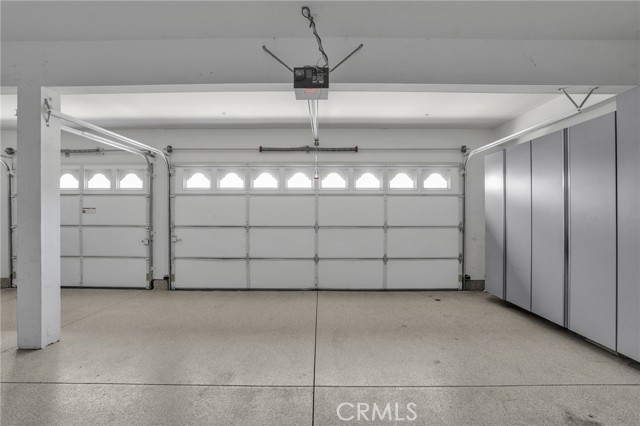 3 car garage with lots of storage cabinets.