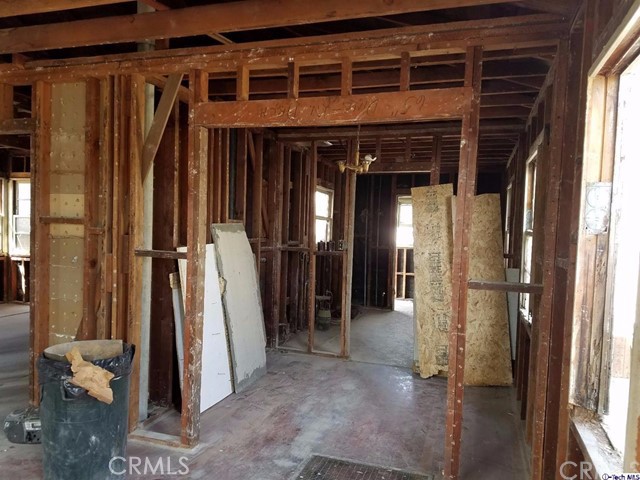 Looking into dining room area, kitchen behind dining room then service porch