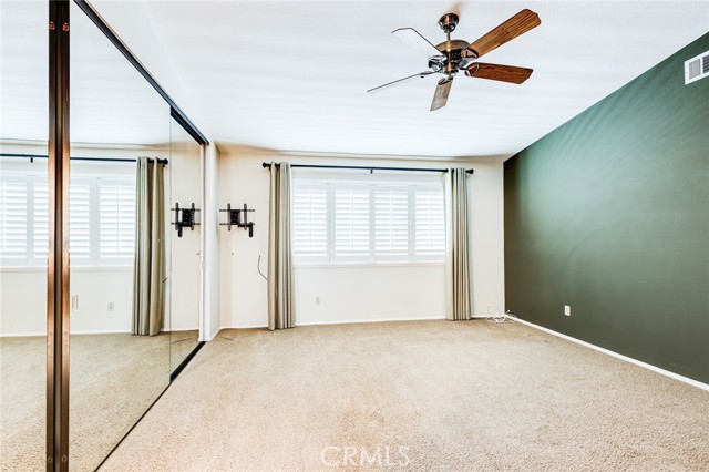 Master Bedroom, Large closet with mirrored doors, ceiling fan and wooden shutters