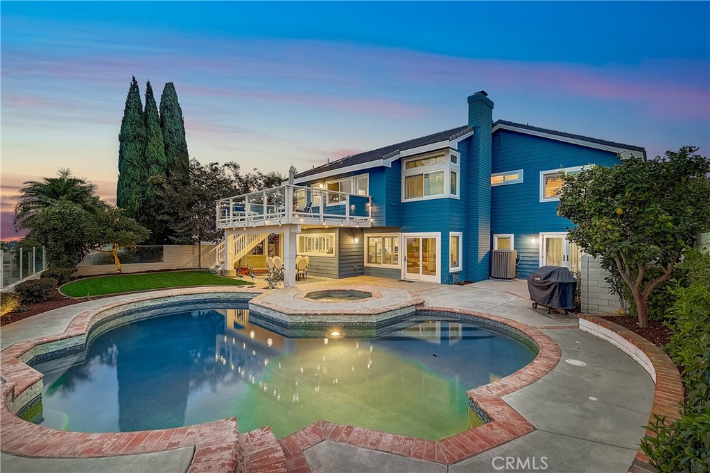 Enjoy GORGEOUS panoramic sunset and city lights views from this Cape Code Beacon Hill Summit home located at the end of a sought-after cul-de-sac.  Warm hardwood floors, plantation shutters and custom wood finishes throughout add to the elegance of the bright and open floorplan. Enter into the inviting living room featuring soaring ceilings and a cozy fireplace that seamlessly flows to the formal dining room. The gourmet kitchen is well-appointed with fresh white cabinets, marble counters and backsplash, stainless steel appliances, Viking range, built-in fridge, beverage fridge, large center island and a breakfast nook with built-in seating. The kitchen opens to the family room featuring decorative wainscoting, built-in shelves, a second fireplace and sliding doors to the backyard. A main floor bedroom offers convenience and privacy for guests, French doors to the backyard and is adjacent to the full downstairs bedroom with a walk-in shower. Upstairs, the primary bedroom offers vaulted ceilings, a retreat area, a spacious and private balcony with gorgeous views, walk-in closet with organizers and a luxurious en-suite primary bathroom with dual vanities, walk-in shower and soaking tub. Down the hall, three secondary bedrooms are generously sized and share a full bathroom with duals sinks.  Relax or entertain with stunning views from the private backyard featuring a sparkling salt water pool, spa and lush green grass.  Enjoy the nearby Beacon Hill community pools, tennis courts, playground, and several parks.  Located near shopping, dinning and entertainment options, award-winning schools and just minutes to Dana Point Harbor and world-renowned beaches.