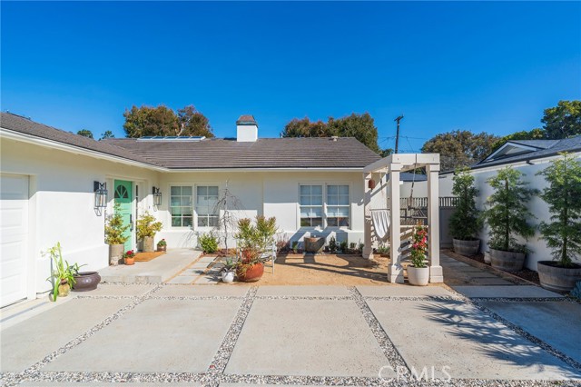 Handsome driveway &  decomposed gravel front  porch with a fountain, and hammock pergola