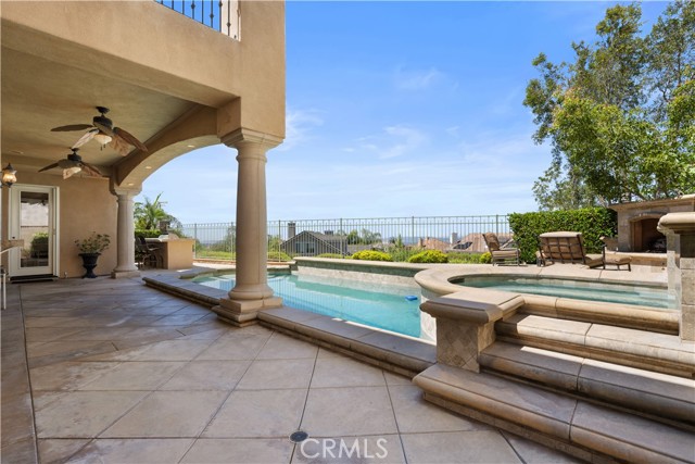 Resort style backyard with pool, spa, fireplace, BBQ bar, covered patio and view!
