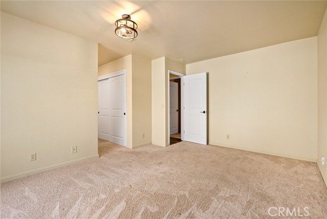 The primary bedroom offers a comfortable spot to relax at the end of the day.