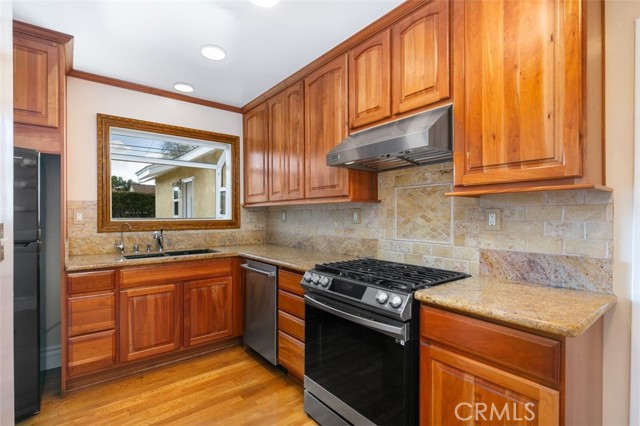 Remodeled kitchen with high end stove and hood. Cute garden window!