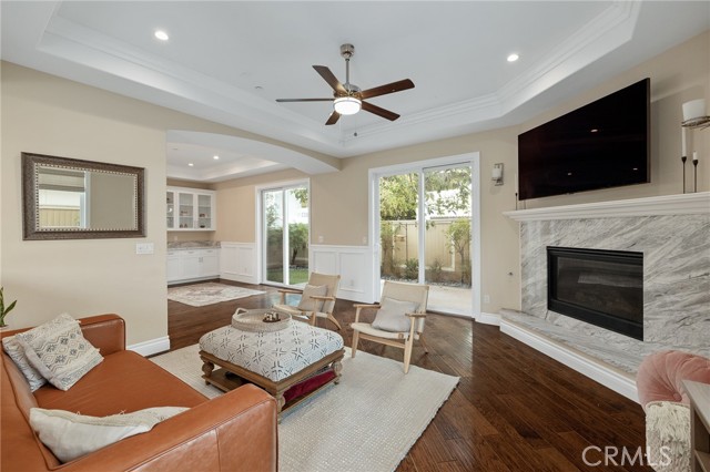 living room features a ceiling fan and fireplace