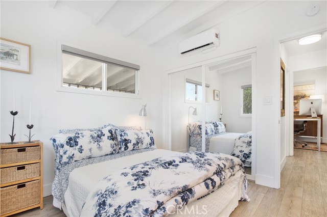 Bedroom one with custom shaker style mirrored closet doors.