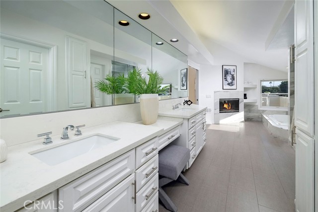 Dual vanity and dual sided fireplace, large tub and steam shower make this Primary Bathroom both a romantic and highly functional retreat.