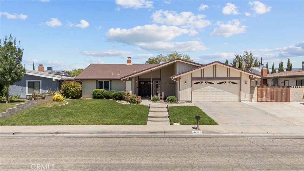 Welcome to your new home! This stunning turn-key single-story home, sits on a 10,298 sq.ft, lot, located in a quiet neighborhood in the highly desired west side of Lancaster/Palmdale. It is perfect for anyone looking for a spacious and comfortable place to live. Upon entering the home, you will be greeted by the family room with a fireplace, adjacent is the formal dining room, and another living area that can be used as an informal dining or TV room. An open concept, updated kitchen with granite countertops, recessed lighting, modern espresso wood cabinets that add a touch of elegance. There is plenty of storage and pantry space, and the kitchen island can double as a breakfast bar. The bonus room, next to the kitchen offers backyard access and is great for entertaining family and friends, can be a home office or a gaming room. The primary bedroom features an en-suite bathroom, dual vanity and a walk-in closet. The 2 additional bedrooms are spacious and there is a full bath conveniently located in the hallway. The laundry room offers ample linen and cabinet storage and grants access to the attached 2-car garage that is pre-wired for an electric vehicle charging port. There is an abundance of parking with RV access that leads to a BONUS 840 sq.ft, insulated detached garage with its own electrical sub panel and AC/Heating, perfect for a workshop or conversion to an ADU. The possibilities are endless! Wood-look tile throughout most of the home. Newer tankless water heater, energy efficient appliances, dual pane vinyl windows, newer central HVAC, ceiling fans, and leased solar panels. Ethernet wiring in 2 rooms, perfect feature if you work from home. Low-maintenance backyard perfect for relaxing in the summer, neighboring trees provide shade and privacy. Buyer is advised to independently verify the accuracy of square footage, 2146 sq ft but county shows 1927 sq ft, lot size, lot lines/dimensions, permitted/unpermitted spaces, or other info concerning the conditions or features of the property.