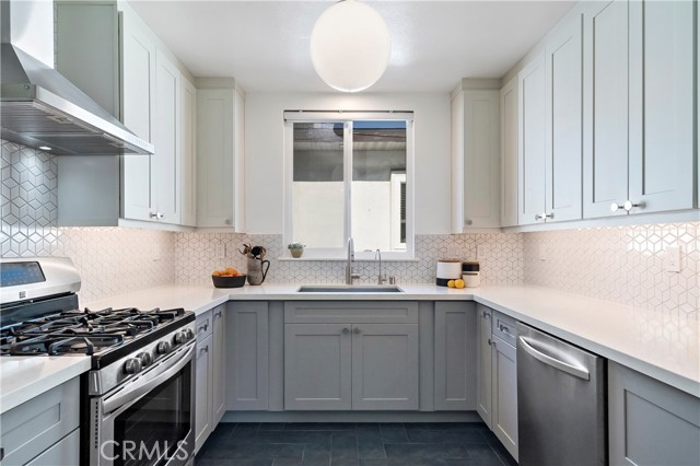 Kitchen with custom pattern backsplash and ceramic tile floor