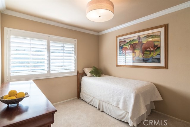 The third bedroom with shutters, crown molding, newer carpet and paint.
