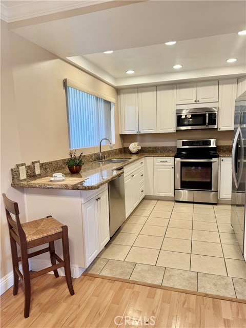 Updated kitchen featuring granite countertops, stainless steel appliances, and a cozy breakfast nook.