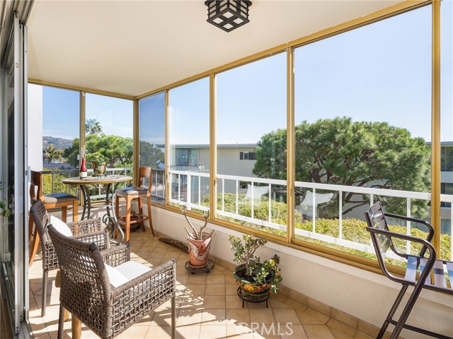 Large, tiled balcony off living room with sufficient space to allow for multiple seating areas.