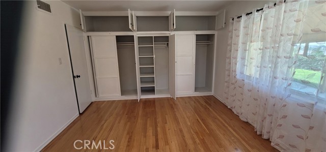 Primary bedroom with storage closets.