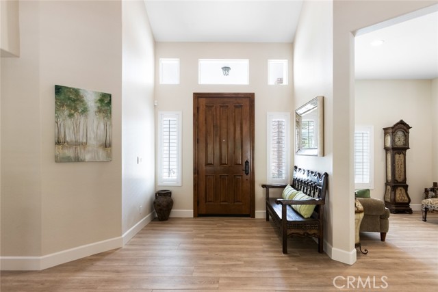 Here's a view of the oversized entry door surrounded by windows that light up the foyer area.