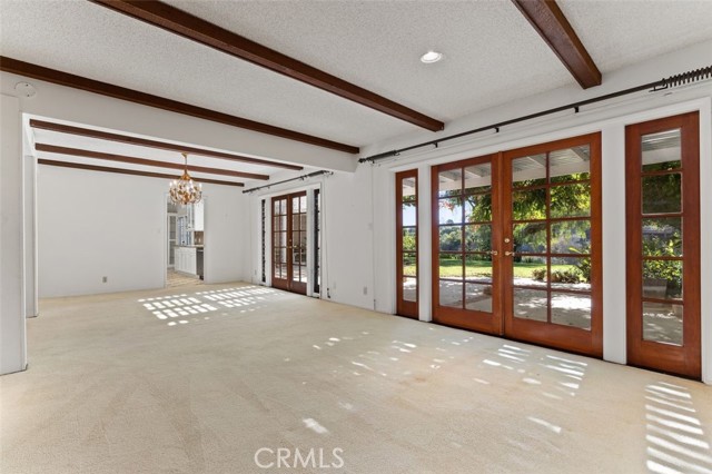 French doors throughout this lovely home open out to the patios, garden and grassy lawns.