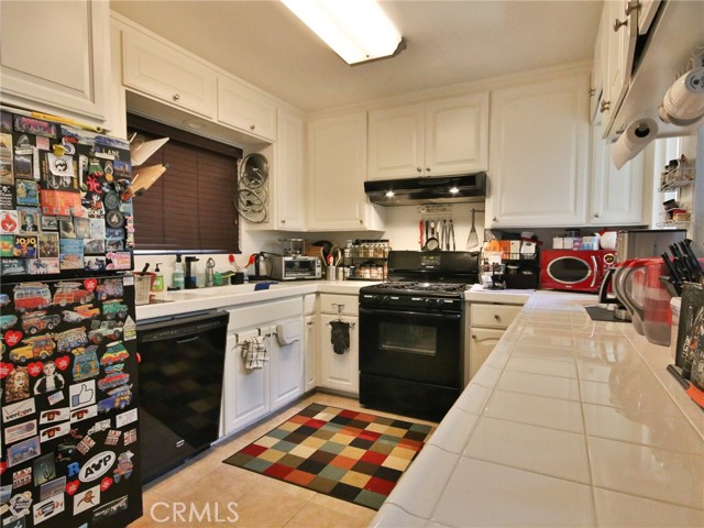 The kitchen for the rear unit showing the dishwasher and range as well as the sink on the left.