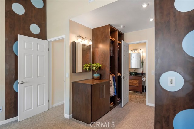 Custom designed closets in large dressing area