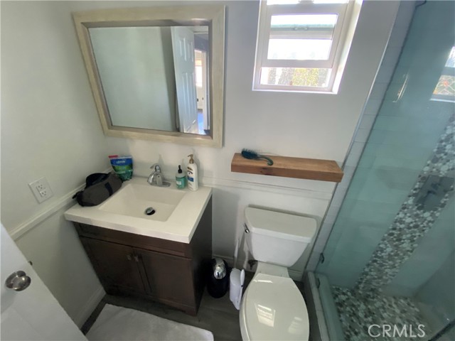 Another totally remodeled bathroom features floor to ceiling tiles