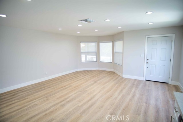 Spacious living room with all new wood flooring.