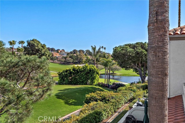 Welcome to an elegant upper level condominium at 52 Tennis Villas Drive, Dana Point, CA. This inviting residence boasts 2 bedrooms and 2 bathrooms within a generous 1357 square feet of living space.

Nestled within the prestigious gated Tennis Villas community in Monarch Beach, this home offers captivating views of the 16th fairway at Monarch Links Golf Course. The sought-after location provides easy access to the association pool and spa, the Tennis Club at Monarch Beach, the Ritz Carlton, Salt Creek beach, and the Waldorf Astoria Resort.

Meticulously renovated with a sleek, modern approach, the interior features all new LVP flooring and carpets, an elegant new kitchen with quartz countertops, custom designer shades, and an extensive use of limestone in the updated bathrooms. The living room showcases a large set of French doors and several large windows framing endless views of the golf course. A fireplace set into a stack-stone accent wall creates a point of interest, while an adjacent view patio area offers a serene space to relax outdoors.

The kitchen is a masterpiece, boasting bespoke contemporary cabinets, a coffered ceiling, quartz backsplash, and high-end stainless appliances, including a Wolf gas range, Miele oven, Bosch dishwasher, and refrigerator. The master bath features sleek custom cabinetry, dual sinks, and a large walk-in shower with a glass enclosure, all illuminated by a skylight. Recessed lighting throughout, a recently installed AC, and a spacious two-car garage add to the allure of this turnkey home.

This refined, end unit home offers a resort-like coastal lifestyle, with easy access to Dana Point Harbor, Strand Beach park, and walking trails that lead directly to the sand. Additionally, the home provides convenient proximity to Laguna Beach, renowned for its culinary delights, world-class shops, art galleries, and beaches.

Don't miss out on the opportunity to own this exquisitely renovated home in a prime location, offering an elegant coastal lifestyle. Schedule a showing today and experience the luxury and sophistication of 52 Tennis Villas Drive.