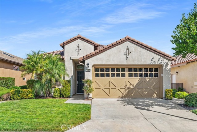 Great opportunity to live in the upscale and meticulously maintained 55+ Community of Trilogy at the foot of the Cleveland National Forest and the Golf Club at Glen Ivy. As you step into the main foyer, you'll immediately notice the light and bright feel with high ceilings and open floorplan in addition to upgraded crown molding, 20-inch ceramic tile, and large baseboards. The open dining and living areas feature plantation shutters which are also throughout the home. A built-in entertainment center is a beautiful focal point of the living room and sliding doors lead to a covered patio with lovely views of the neighborhood below. Heading into the heart of the home, you'll be greeted by the natural light streaming through the kitchen skylight. The kitchen boasts fresh white cabinets, newer stainless-steel appliances, and granite countertops. There's also a spacious pantry and a breakfast bar perfect for casual dining. Located off the kitchen is the laundry room that leads to the garage which has epoxy flooring and an abundance of high end cabinetry for lots of storage! The large primary bedroom offers a ceiling fan, walk-in closet, mounted TV, a walk-in shower, dual sinks, and a private toilet room. The second bedroom, with cozy carpet and ceiling fan is located just off the hallway as you enter and is connected to the second bathroom, which has a new step in soaking tub, and also serves as the guest bath. Ample storage is available with hallway closets near both bedrooms. The entire home has been freshly painted inside and out, adding to the move-in ready appeal. The community’s HOA provides endless amenities, including a golf course, restaurant, fitness center, indoor and outdoor pools, aerobics and dance studio, indoor walking track, tennis courts, craft and meeting rooms, billiard rooms, walking and biking trails, an outdoor amphitheater, RV/boat parking, outdoor patio areas, and much more!