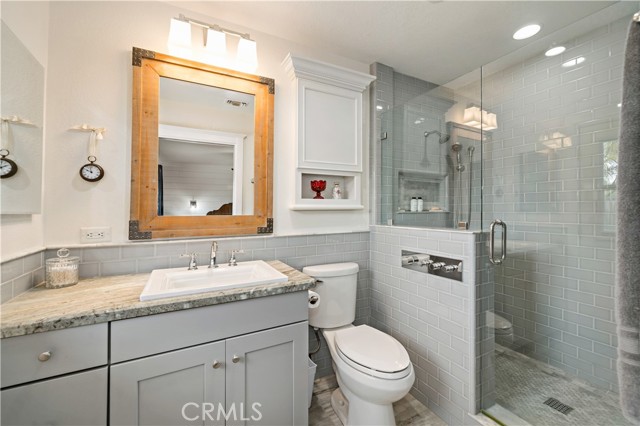 master bath with walk in dual head shower and adjustable climate control