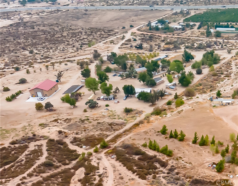 Imagine the freedom of owning this compound on 19.39 acres that are sub dividable according to the County- mostly flat with flexible uses from agriculture to animals and residences. Easy access directly off Hwy 138 under 4 miles to I-15 Cajon Junction. 2 wells (the one in use has in incredible 18 GPM flow according to Seller), Seller estimated 13.86 kW OWNED Solar system. 7 structures that can be lived in totalling about 5,000 square feet according to Seller (One house and RV garage are permitted) estimated 3,500 square foot RV garage with added living space- 2 beds 2 baths and kitchen and estimated 11.5' wide by 14' tall RV Door and 18' ceilings. estimated 2145 sq ft old barn. 6 storage structures with about 1500  square feet. The solar powers two separate sections of the ranch with 2 separate electric meters. There are 2 septic systems, water tanks, propane tanks (not in use now with solar). Some fruit trees and much of the property is fenced. This unique West Cajon Valley property offers unlimited potential, though it feels rural, it is situated along Hwy 138, 3.5 miles West of the I-15 Fwy and the Cajon Junction. 20 minutes away from Mountain High Ski Resort. Zoned Rural Living, can be subdivided according to the County. Property is sold as-is. Buyer to verify all information.