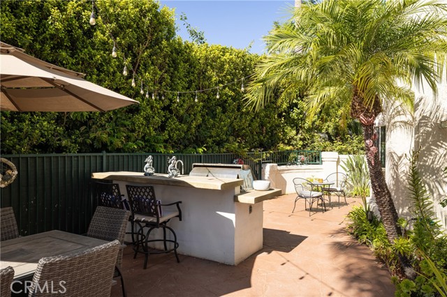 A Twin Eagles outdoor kitchen with BBQ, sink and dual burners, and multiple patio settings ready for relaxation or al fresco dining.