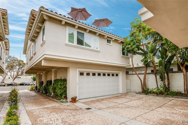 Detached home showing 2 car garage and rooftop deck