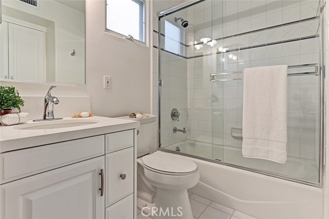 first level bedroom's bathroom with white quartz slab counter