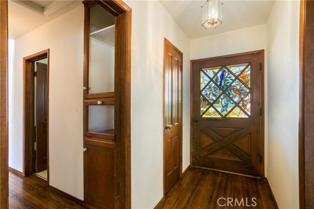 Custom stain glass windows, such as this in the entry, are featured throughout.