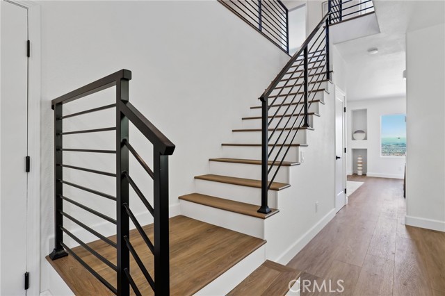 The stylish black iron staircase leads to the second floor with four bedrooms and one guest bathroom.