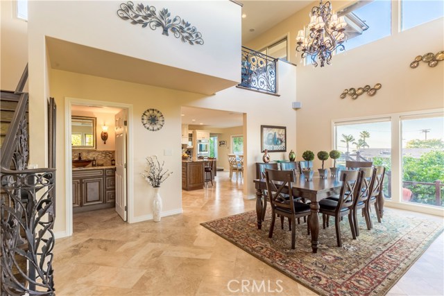 Dining room with two-story ceiling open to loft.