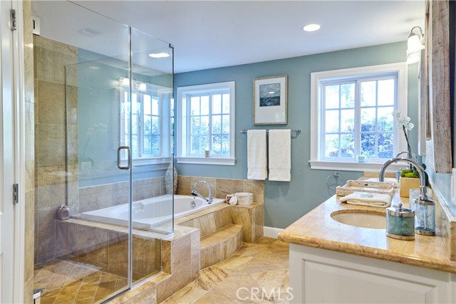 Master en-suite bathroom with stone shower, tub and dual sinks