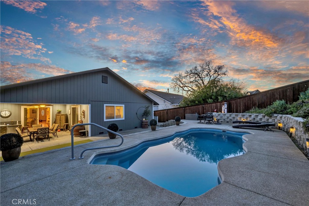 STAYCATION! This single level 3 bed / 2 bath home has 1,627 SF & is situated across the street from Hidden Valley Lakes 18 hole Championship Golf Course. BACKYARD PARADISE! Take a dip in your private INGROUND POOL, relax & entertain at the covered patio with OUTDOOR KITCHEN plumbed with propane, water, & power for convenience! Solid Redwood fencing. Impeccable landscaping front & back- terraced with several entertaining areas, drought tolerant plants & artificial turf enhances outdoor enjoyment. The formal entry leads to an open floorplan viewing the living, dining, & kitchen areas with bamboo flooring and beautiful tray ceilings with recessed lighting. The Kitchen offers granite countertops, center island with butcher block, stainless steel appliances including refrigerator + wine cooler, soft closing cabinetry & a full pantry. Easy backyard access via sliding glass doors at the living room & primary bedroom. Bedrooms include carpet, ceiling fans & are quite spacious. Primary with large walk-in closet & ensuite bath including tiled flooring & upgraded vanity. Indoor laundry with "like new" washer/dryer included! Plenty of room for storage in the large 2 car garage with workbench area or added storage shed. RV/Boat storage via gravel parking pad on the side of the home! Newer exterior paint, water softener system & new smart water monitor to help with insurance requirements! A golf cart is included to sweeten the deal! The good life awaits at this incredible Hidden Valley Lake OASIS - what more could you ask for!?