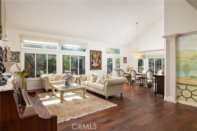 The light-filled living and dining area boasts vaulted ceilings, hardwood floors, and a fireplace, adjacent to your two main-floor ensuite bedrooms.