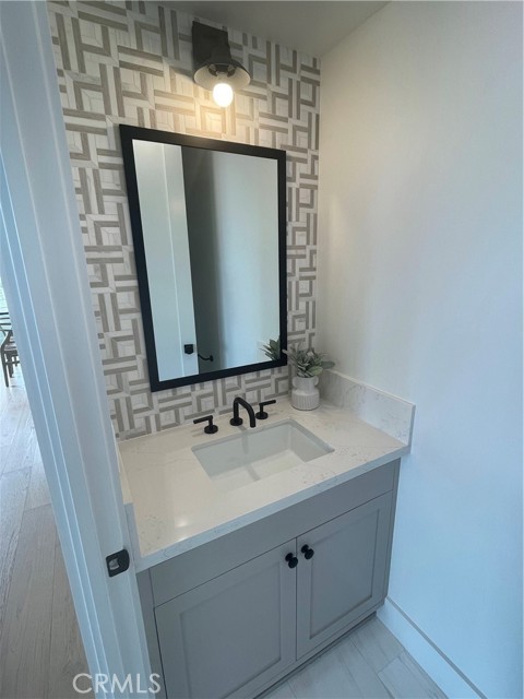Powder Room with Tile by Details Design at PCH And Aviation