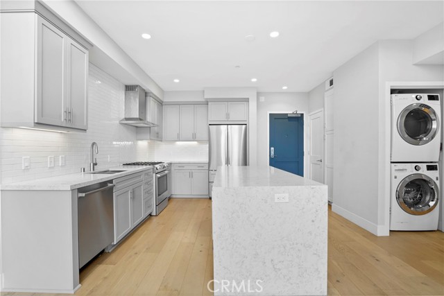 Washer and dryer to the right of kitchen.