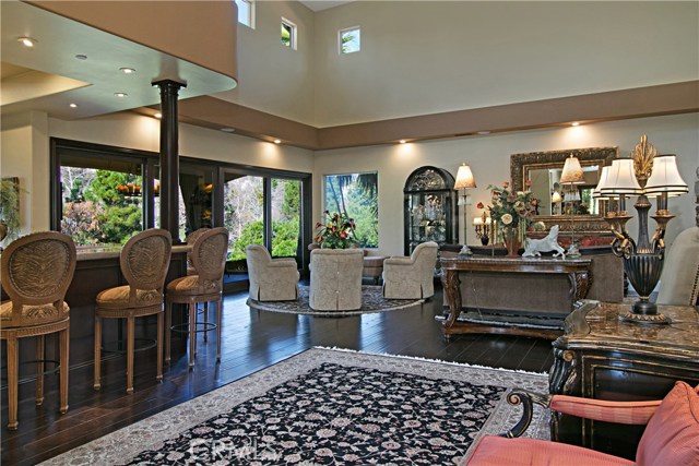 The Family room is an entertainers delight with a floor to ceiling double sided stacked rock fireplace, as well as a walk behind wet bar.